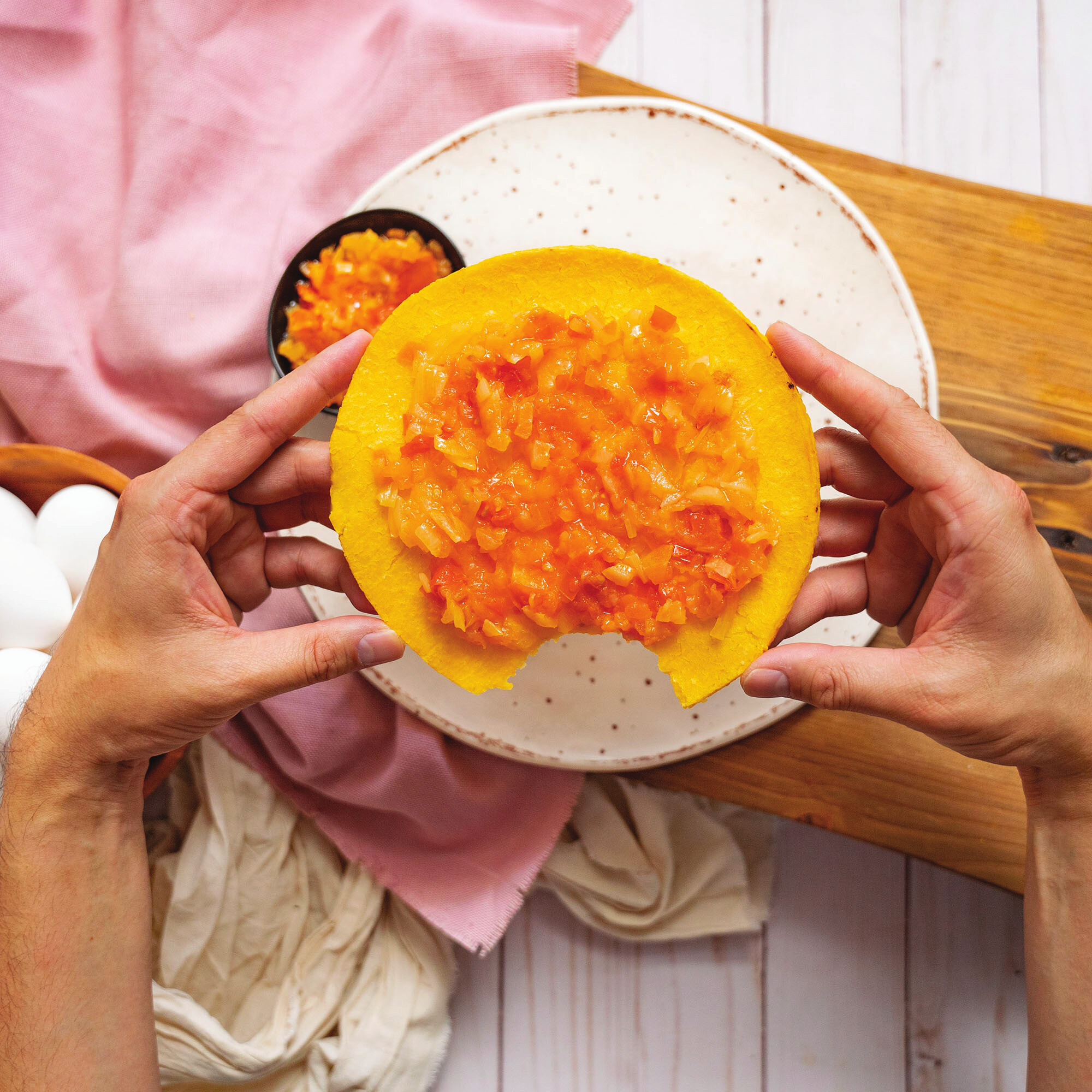 Colombian arepa topped with fresh guiso